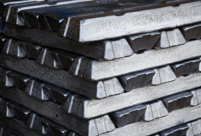Stack of zinc alloy ingots, raw material for manufacturing rugged and EMI-shielded professional audio connector shells.
